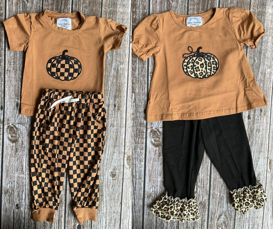 Pumpkin sibling matching outfits with boys checkerboard pumpkin jogger set and girls leopard pumpkin ruffle pants set in warm caramel and black fall colors.