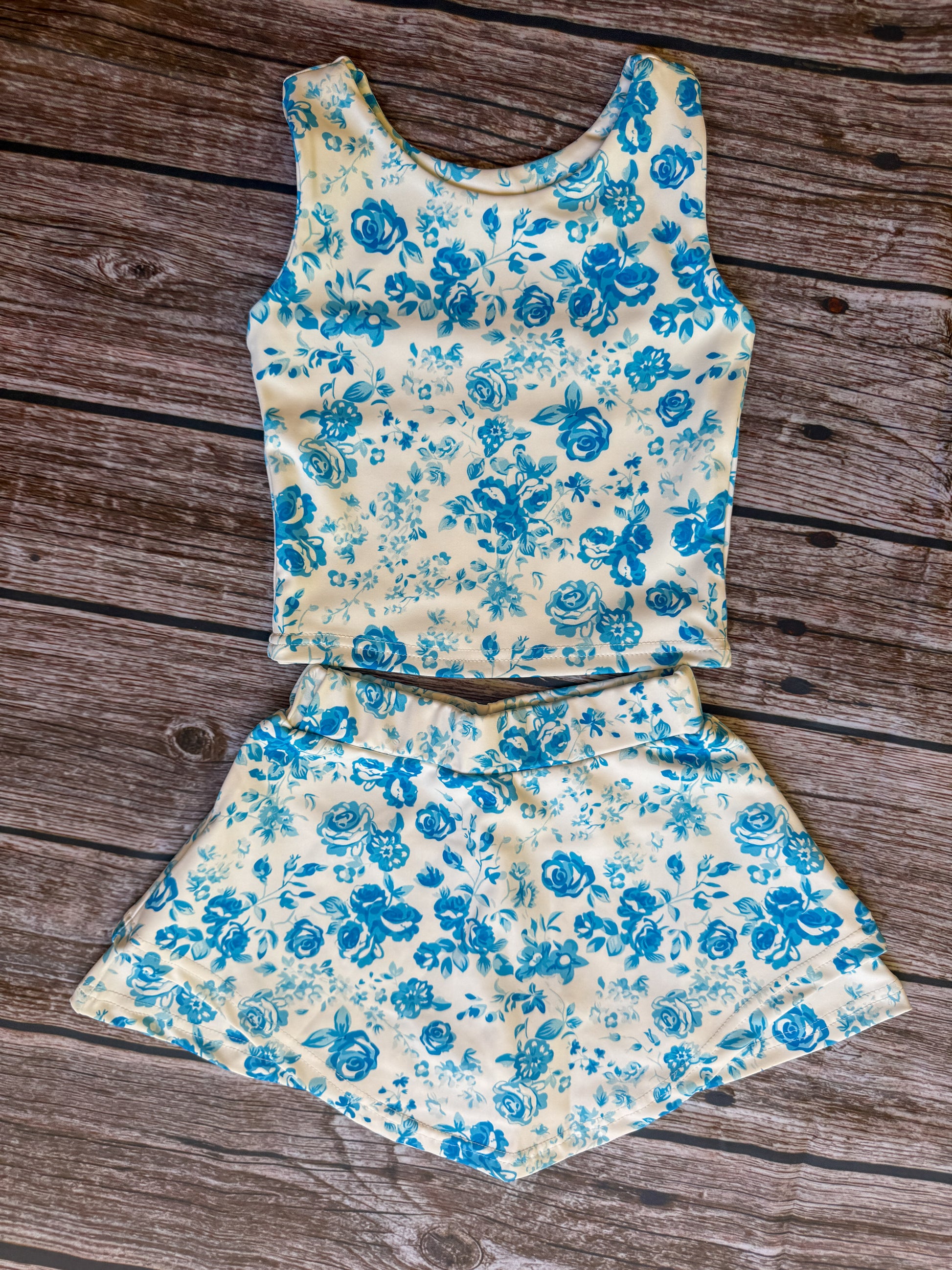 Bailey’s Floral girls athletic skort set with sleeveless top and matching blue floral skort.