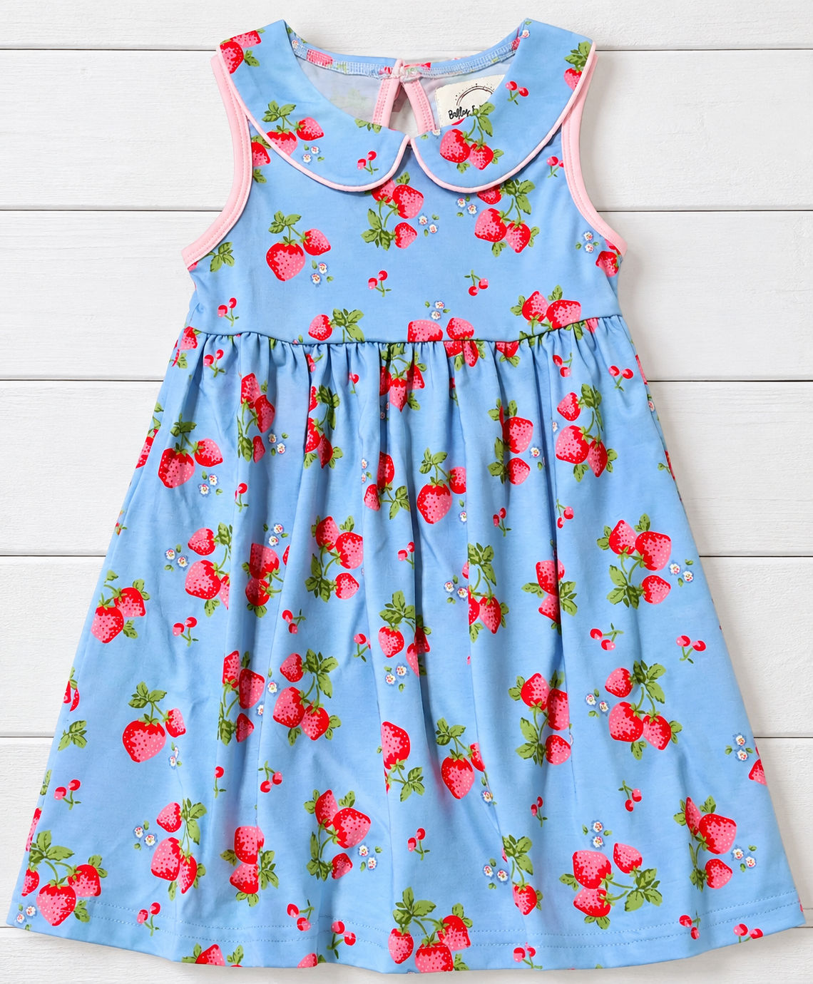 Girls blue sleeveless strawberry print dress with pink piping and rounded collar