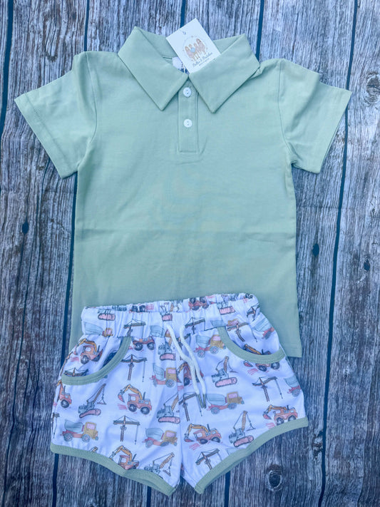 Boys sage green polo with construction truck print shorts featuring excavators, dump trucks and cranes