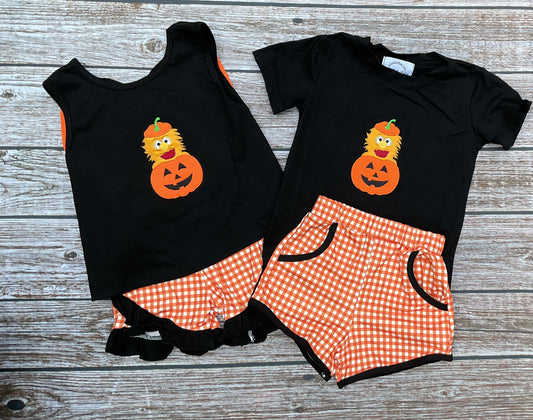 Halloween Herbie sibling matching outfits with boys and girls black pumpkin appliqué tops and orange gingham shorts.