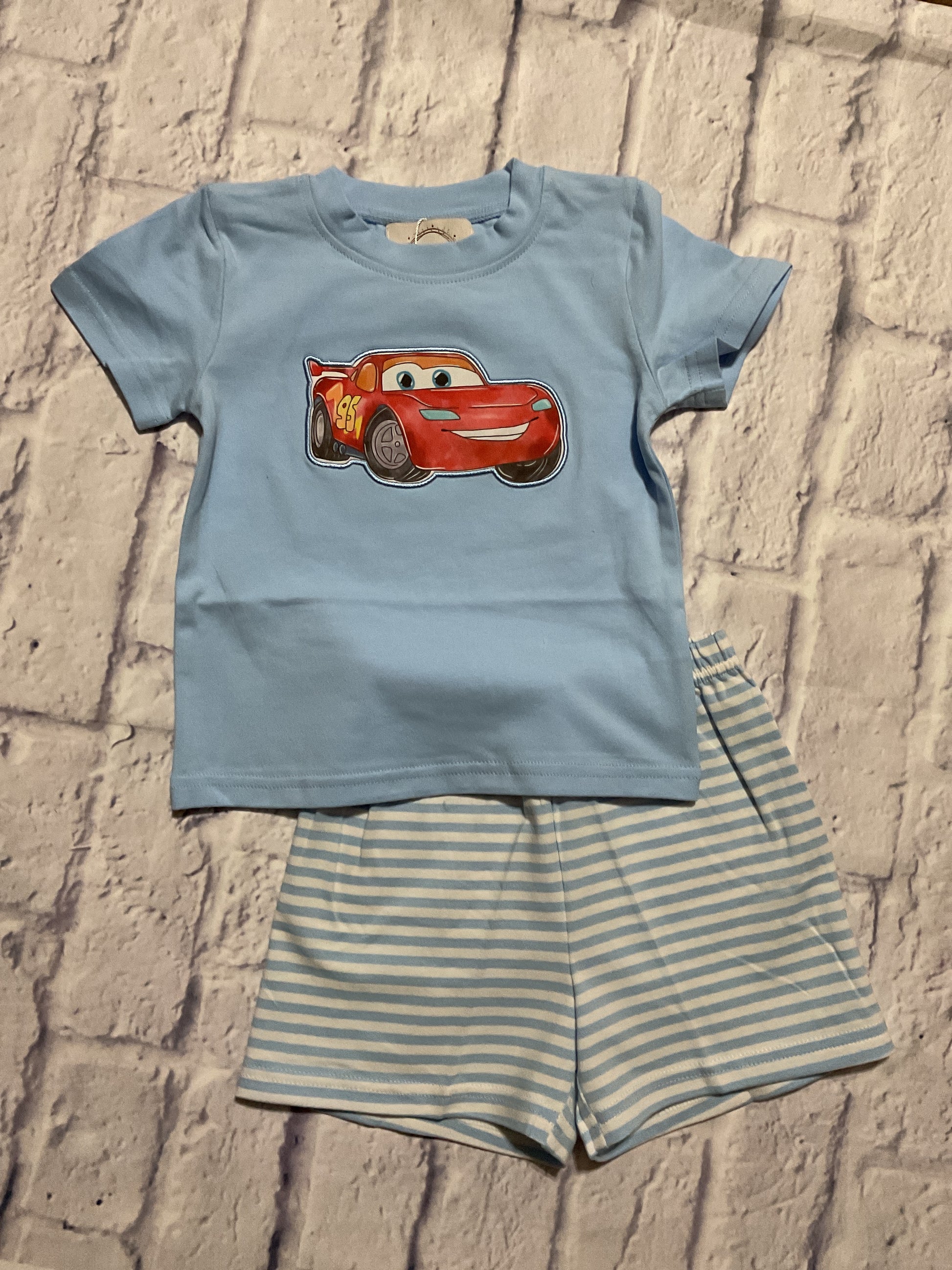 Boys light blue short set with red race car appliqué and blue and white striped shorts