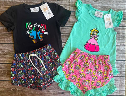 Level Up Cuties sibling match collection with boys black gaming short set and girls mint green princess top with pink ruffle shorts.