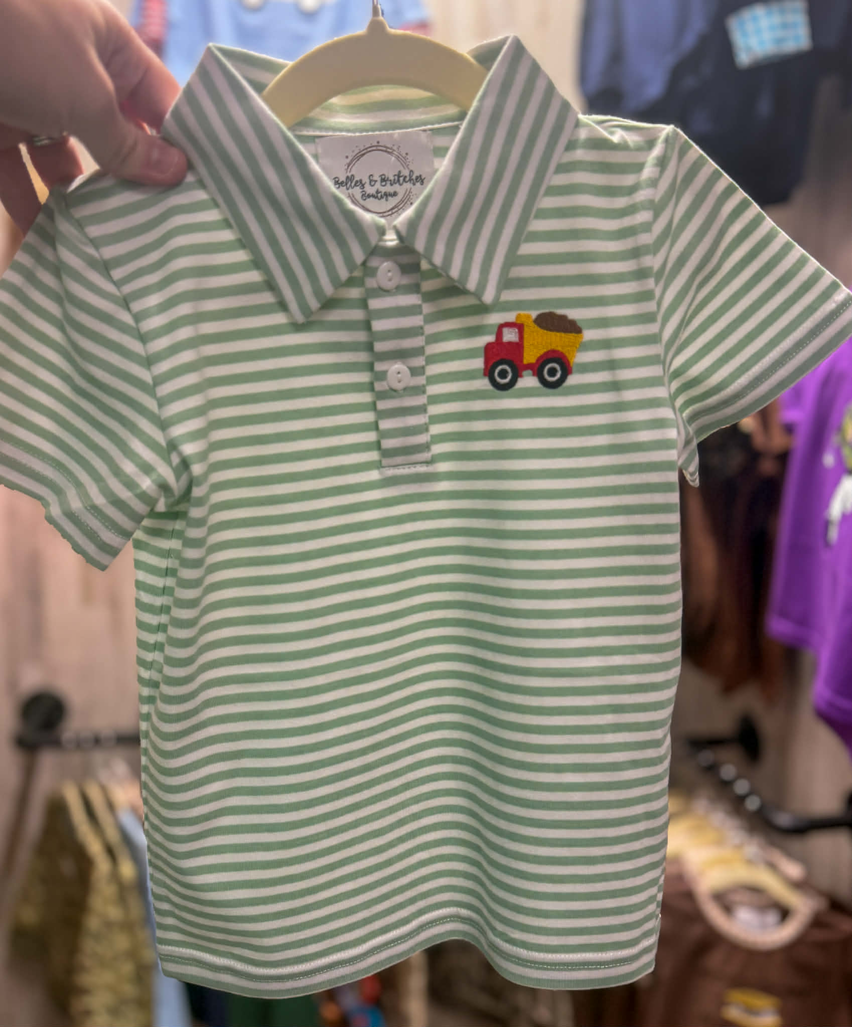 Boys green and white striped polo shirt with colorful embroidered dump truck
