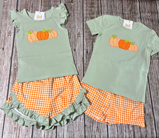 Little Pumpkin Trio sibling matching outfits with sage green pumpkin appliqué tops and orange gingham shorts for boys and girls.