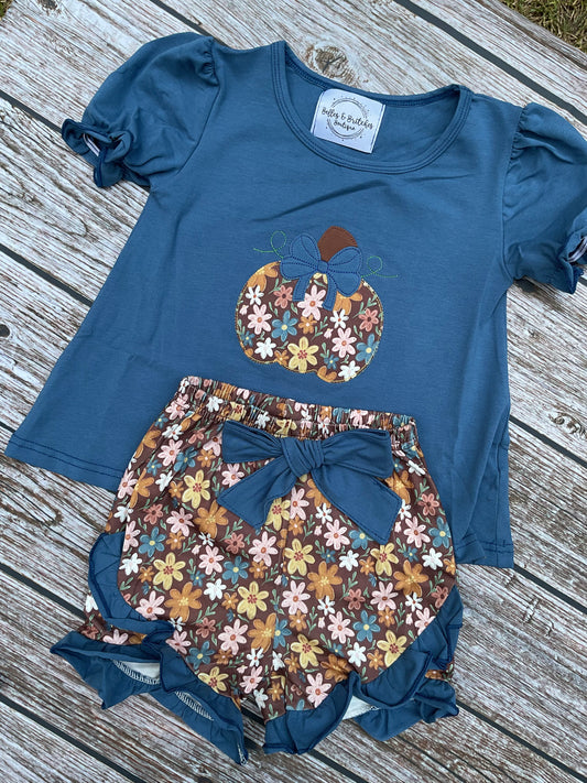 Precious Pumpkins girls fall short set with blue floral pumpkin appliqué top and brown floral ruffle shorts with bow.