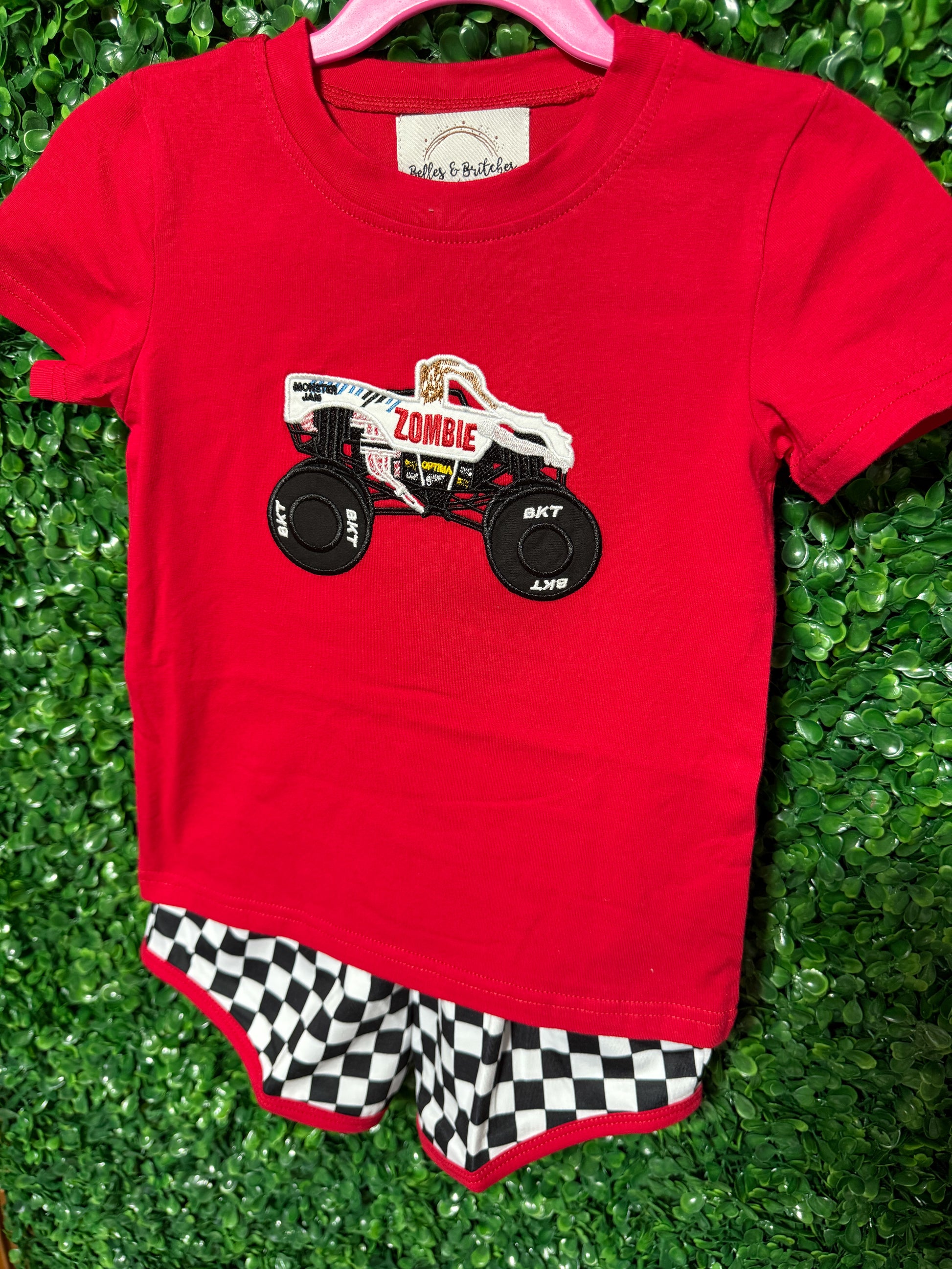 Boys red monster truck shirt with black and white checkered shorts and red trim