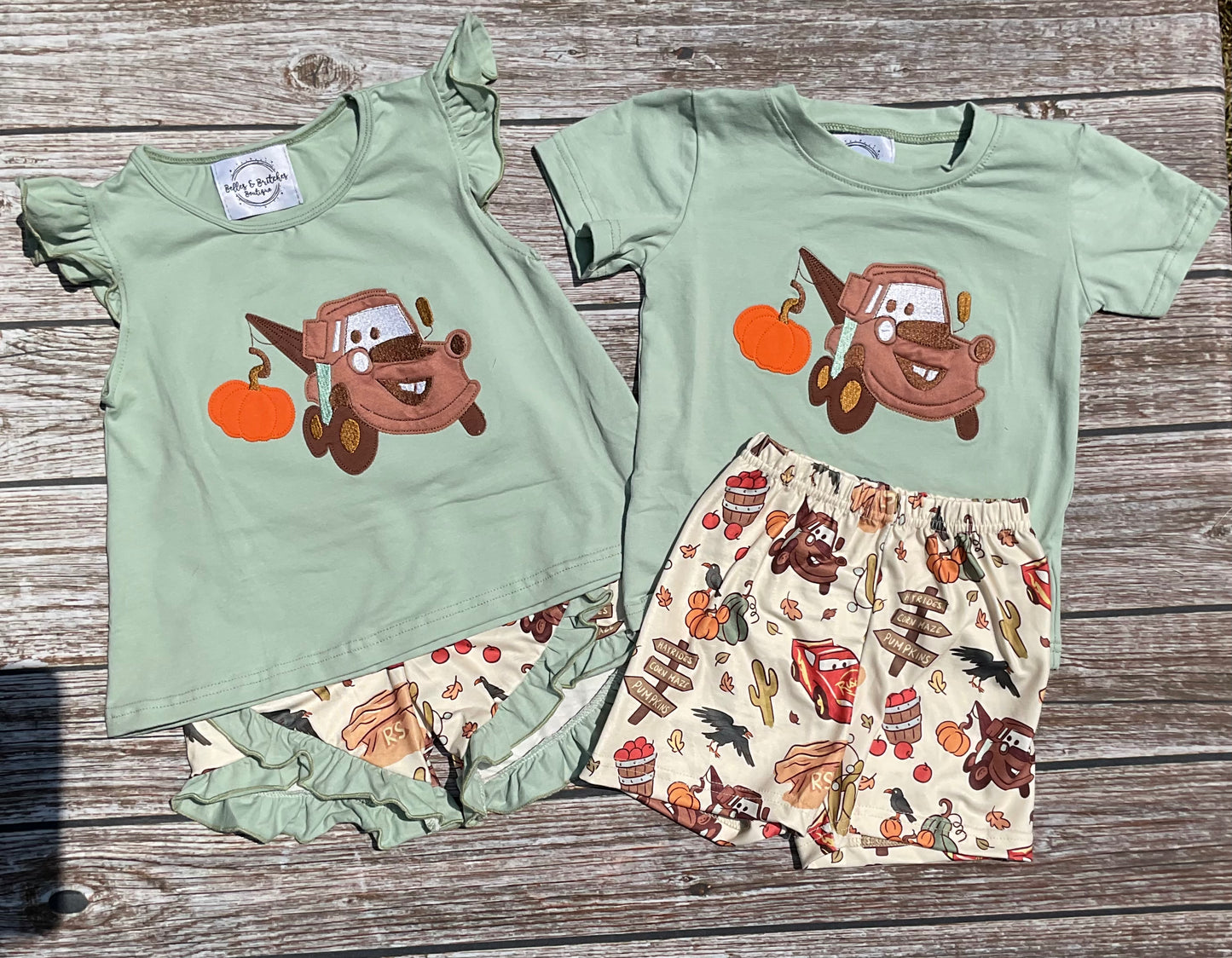Towin’ Pumpkins boys and girls sibling matching fall short sets with sage green tow truck pumpkin appliqué tops and coordinating printed shorts.