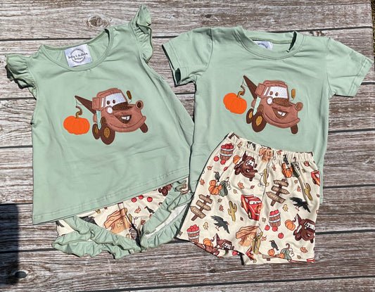 Towin’ Pumpkins boys and girls sibling matching fall short sets with sage green tow truck pumpkin appliqué tops and coordinating printed shorts.