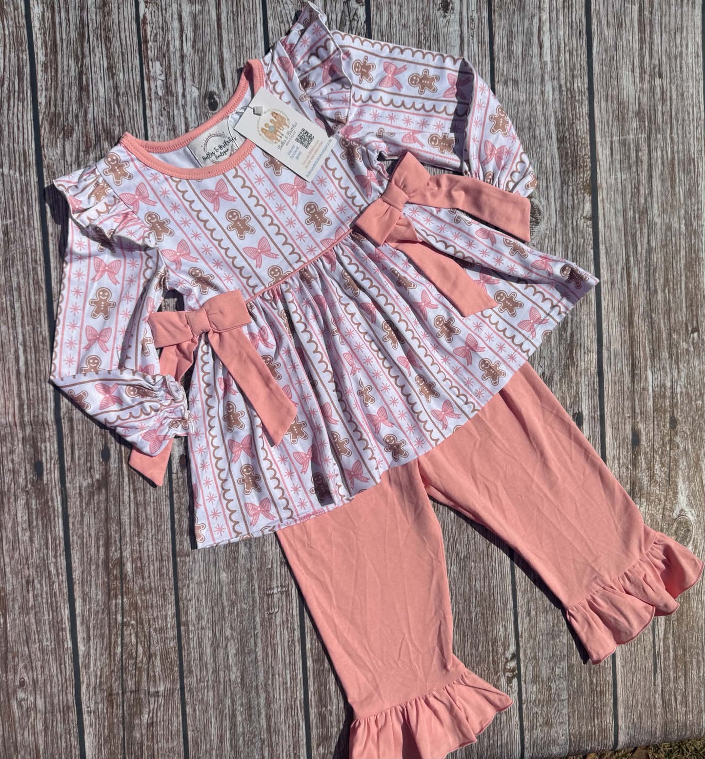 Girls Christmas pants set with gingerbread and pink bow print tunic, decorative bows and pink ruffle bell bottom pants