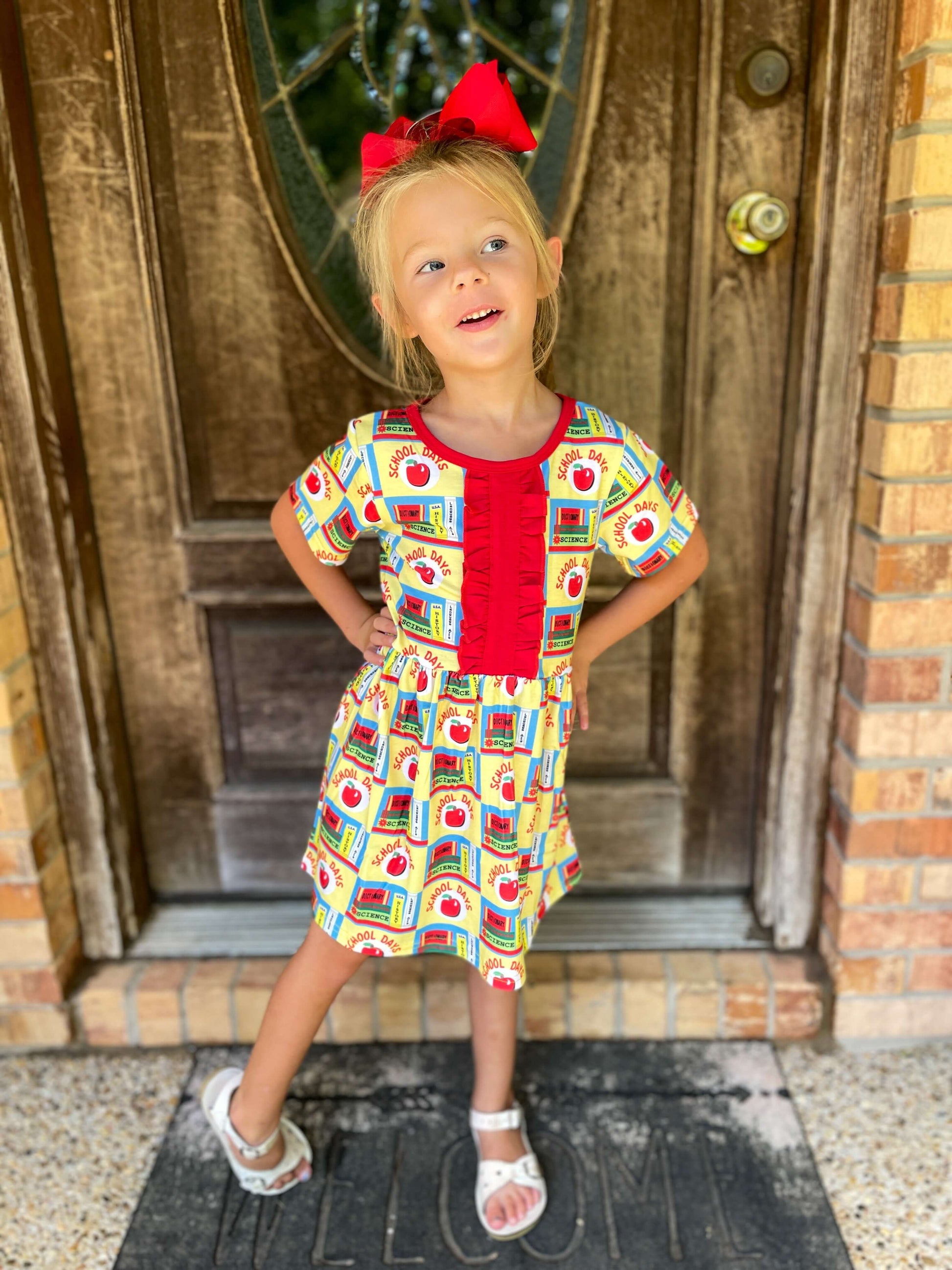 image of girl wearing Back to School Apple & Books Print Dress