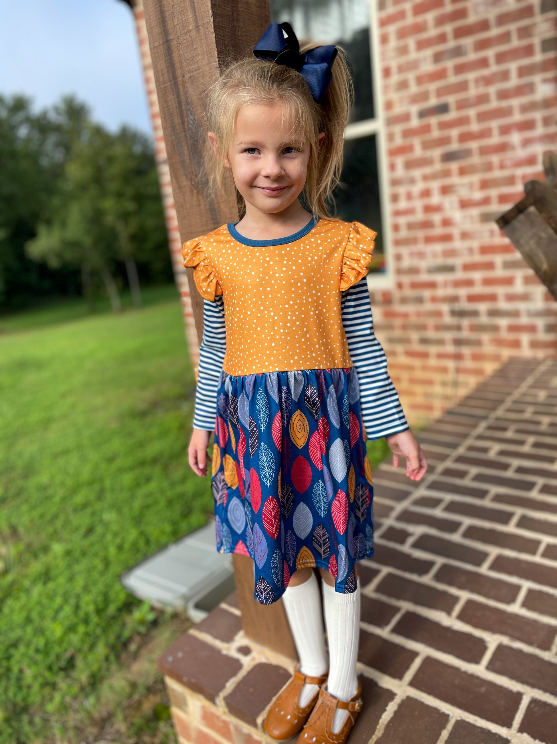 image of child wearing Blue & Yellow Fall Leaves Dress